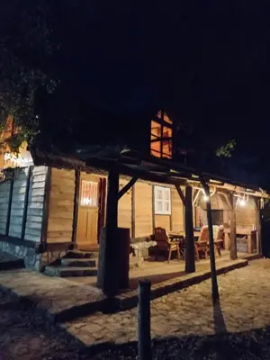 a house with a lit up porch at night at Magaze de Luxe in Gradačac