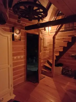 a hallway in a log cabin with a stairway at Magaze de Luxe in Gradačac