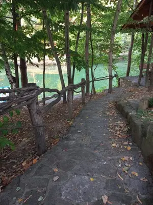 a path next to a fence next to the water at Magaze de Luxe in Gradačac