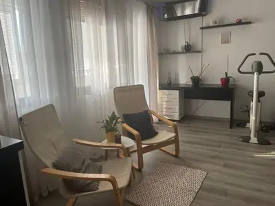 a living room with two chairs and a piano at Bajka centar in Bosanska Gradiška