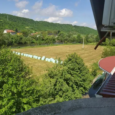 an aerial view of a field with trees and a hill at Vila Zvizdic- apartman in Ilijaš