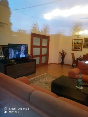 a living room with a couch and a flat screen tv at Vila Zvizdic- apartman in Ilijaš