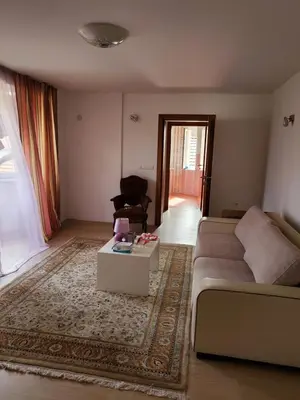 a living room with a couch and a coffee table at Vila Zvizdic- apartman in Ilijaš
