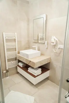 a bathroom with a sink and a mirror at Edemus - Motel & Restaurant in Maglaj