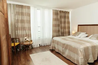 a hotel room with a bed and a window at Edemus - Motel & Restaurant in Maglaj