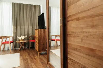 a room with a sliding door with a television on it at Edemus - Motel & Restaurant in Maglaj