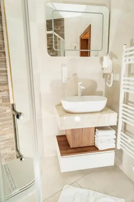 a bathroom with a sink and a mirror at Edemus - Motel & Restaurant in Maglaj