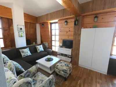 a living room with a couch and a table at Apartman Nancy Vlašić in Vlasic