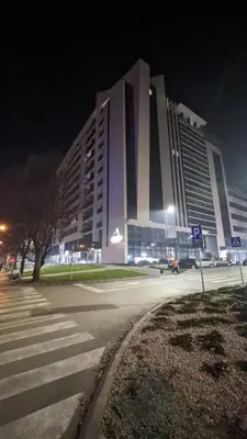 a large building on a city street at night at Yellow Submarine apartment Banja Luka in Banja Luka