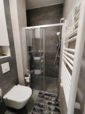 a bathroom with a toilet and a shower at Yellow Submarine apartment Banja Luka in Banja Luka
