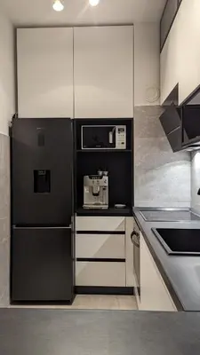 a kitchen with a black refrigerator and white cabinets at Yellow Submarine apartment Banja Luka in Banja Luka