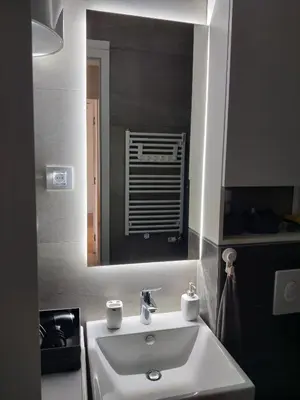 a bathroom with a white sink and a mirror at Yellow Submarine apartment Banja Luka in Banja Luka