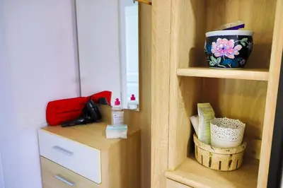 a wooden cabinet with a bowl on a shelf at Apartman Ozimice 2 in Bihać