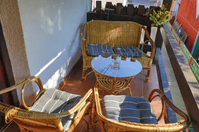 a balcony with chairs and a table and a table and chairs at Apartman Ozimice 2 in Bihać