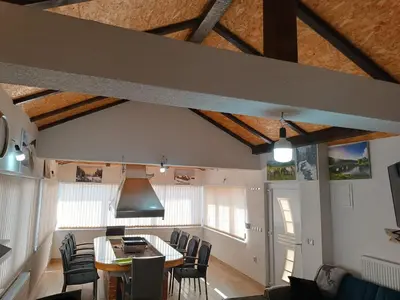 a living room with a dining room table and chairs at Apartman Kaja in Kupres