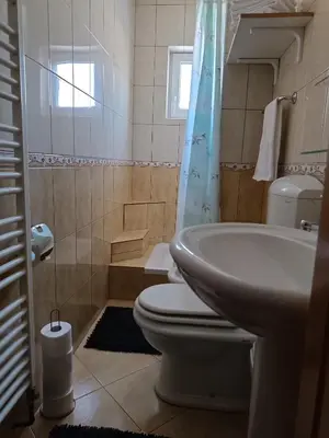 a bathroom with a toilet and a sink at Apartman Kaja in Kupres