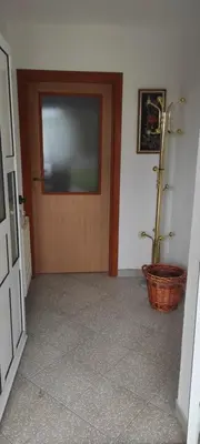 a hallway with a door with a television on it at Apartman Kaja in Kupres