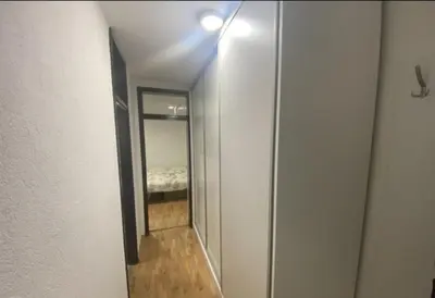 a hallway leading to a bedroom with a mirror at Stan na dan Tenis in Prijedor