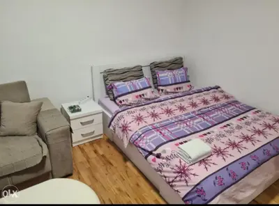 a bedroom with a bed and a couch at Stan na dan Tenis in Prijedor