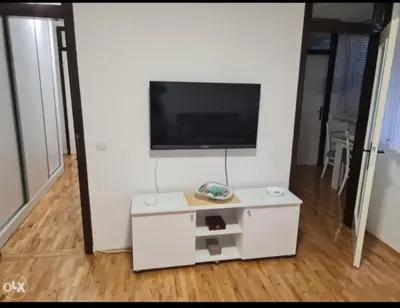 a living room with a tv on a white wall at Stan na dan Tenis in Prijedor