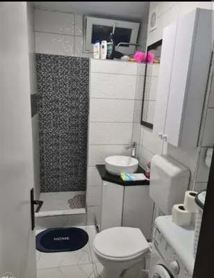a small bathroom with a toilet and a sink at Stan na dan Tenis in Prijedor
