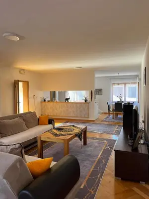 a living room with a couch and a table at Sunrise Apartment in Visoko
