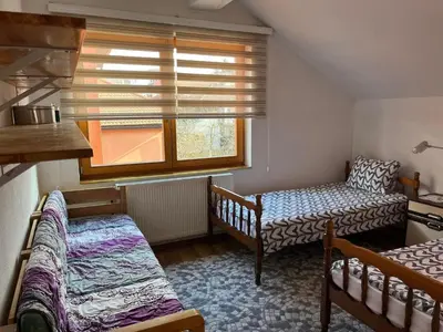 a small room with two beds and a window at Sunrise Apartment in Visoko