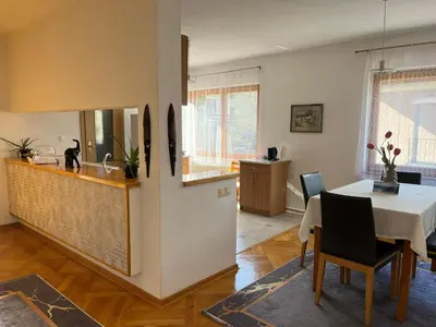a kitchen and a dining room with a table at Sunrise Apartment in Visoko