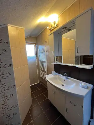 a bathroom with a sink and a mirror at Sunrise Apartment in Visoko