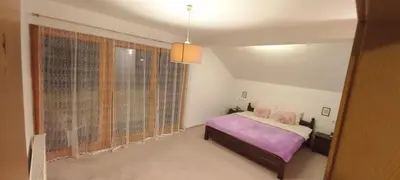 a bedroom with a bed and a large window at Sunrise Apartment in Visoko