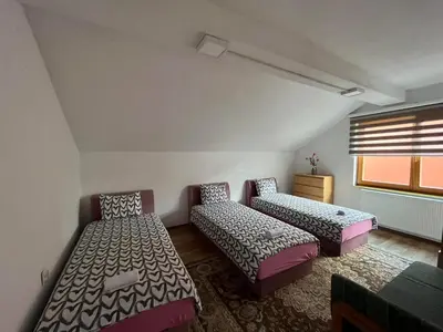 a room with two beds and a window at Sunrise Apartment in Visoko