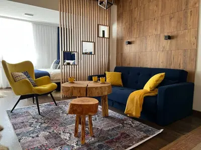 a living room with a blue couch and a table at Apartment Blue Eko Fis Vlašić in Vlasic