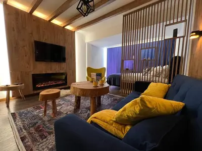a living room with a blue couch and a fireplace at Apartment Blue Eko Fis Vlašić in Vlasic