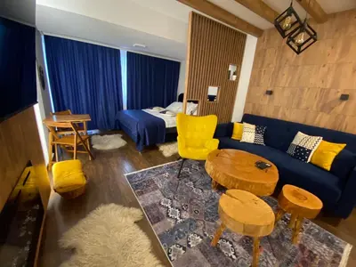 a living room with a blue couch and a table at Apartment Blue Eko Fis Vlašić in Vlasic