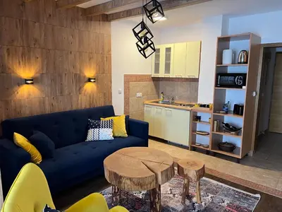 a living room with a blue couch and a table at Apartment Blue Eko Fis Vlašić in Vlasic