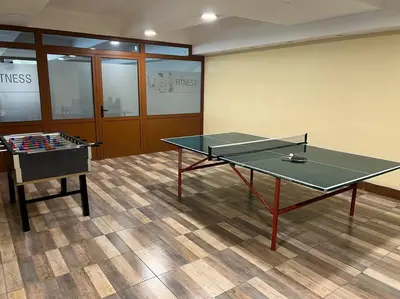 a room with a ping pong table and a foos ball at Apartment Blue Eko Fis Vlašić in Vlasic
