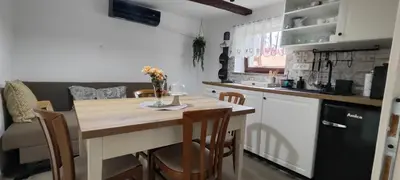 a kitchen with a table and chairs in a kitchen at Begova kuća-Velika Kladuša in Velika Kladuša