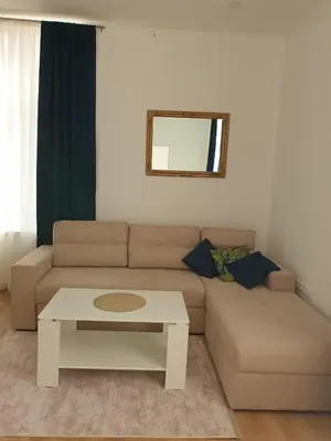 a living room with a couch and a table at Apartmani Marić in Gornji Vakuf