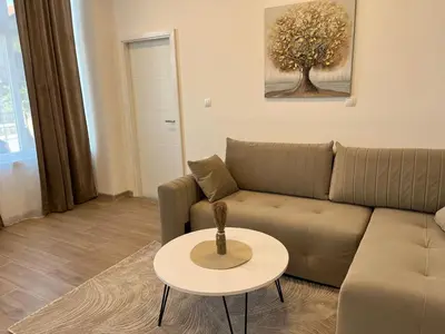 a living room with a couch and a table at Apartmani Marić in Gornji Vakuf