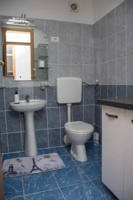 a bathroom with a toilet and a sink at Apartman Vesna in Doboj