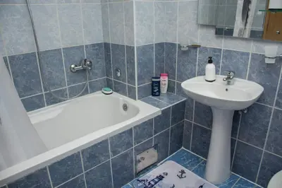 a bathroom with a sink and a tub and a toilet at Apartman Vesna in Doboj