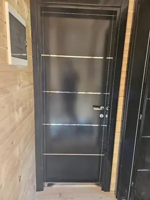 a black door with metal shelves in a room at Etno Selo RELAX in Šipovo