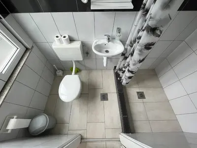 a small bathroom with a toilet and a sink at Hotel Neron Bihać in Lohovo