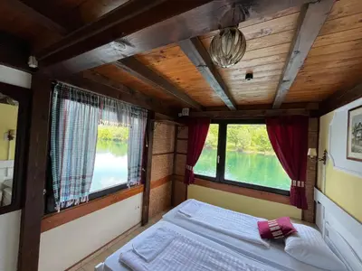 a bed in the back of a train with windows at Hotel Neron Bihać in Lohovo