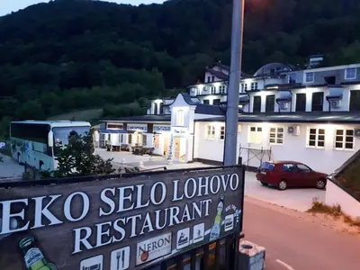 a sign for a leico sellado lounge restaurant in a town at Hotel Neron Bihać in Lohovo