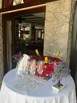 a table with wine glasses on top of it at Hotel Neron Bihać in Lohovo