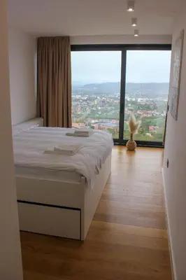 a bedroom with a bed and a large window at Villa Wineyard - VinoGrad in Banja Luka