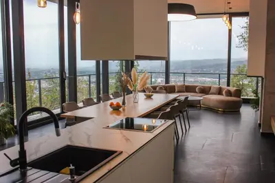 a kitchen with a view of a living room at Villa Wineyard - VinoGrad in Banja Luka
