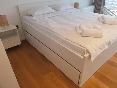 a bed with white sheets and towels on it at Villa Wineyard - VinoGrad in Banja Luka