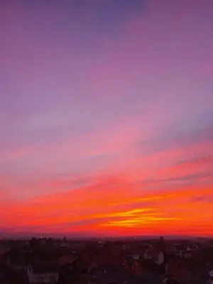 a sunset over a city with a pink at XENA Centar Gradiška in Bosanska Gradiška